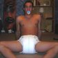 A Diaper Nipple Man, who appears to be a baby boy, is seated on the floor.