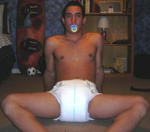 A Diaper Nipple Man, who appears to be a baby boy, is seated on the floor.