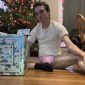 In front of the gift box, a Panties Man is seated on the ground.