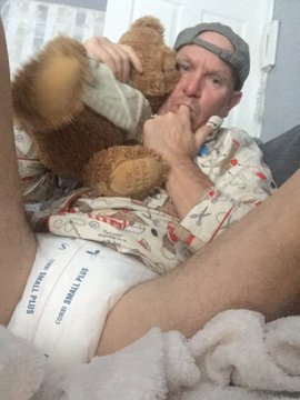 Teddy bear and a Finger Sucking Man are sitting together.