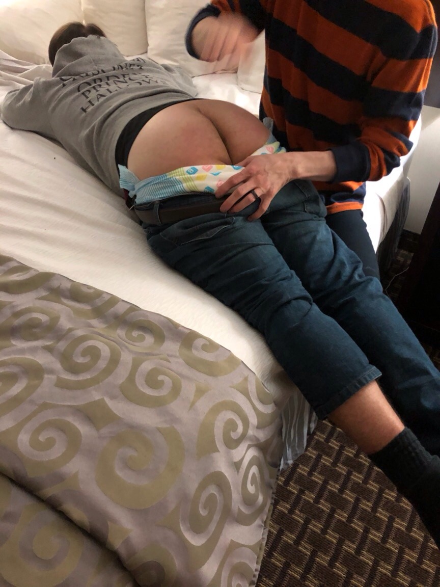 Adult Disgraceful Diapering the other man while he is lying on the bed and exposing his butt